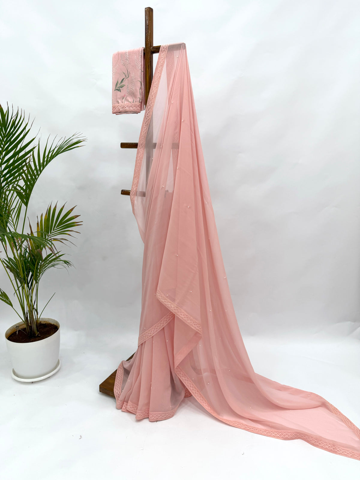 PEACH GEORGETTE SAREE WITH PEARL EMBELLISHMENT AND FLORAL BLOUSE FABRIC